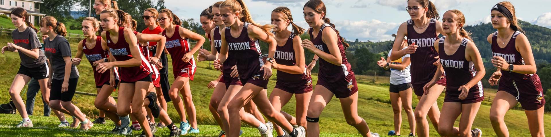 The LI Girls Cross Country team leaves the starting line at the start of the race course at Kingdom Trails. 